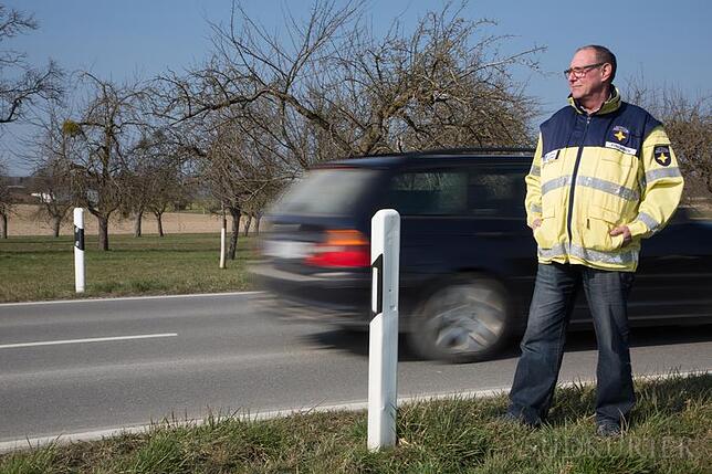Notfallseelsorger: Fritz Möhrle steht an einer Straße im Hegau, ein Auto fährt an ihm vorbei. Nicht selten wird er zu Unfällen mit ...
