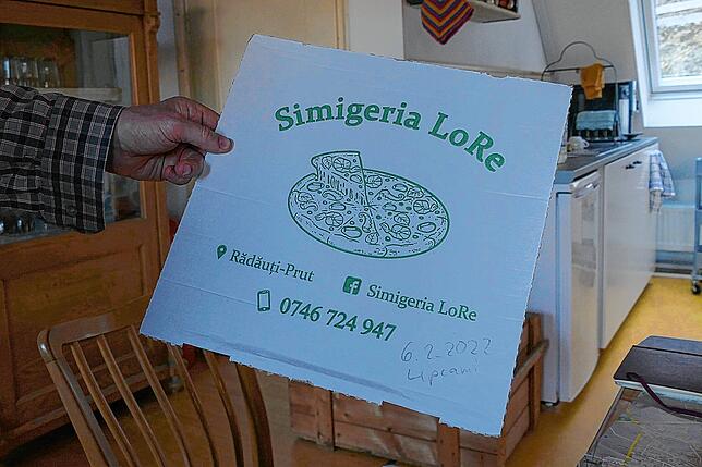 Im Flüchtlingslager im rumänischen Rdui-Prut bringen Helfer abends Pizza für Harald Sondhof und Werner Knubben.