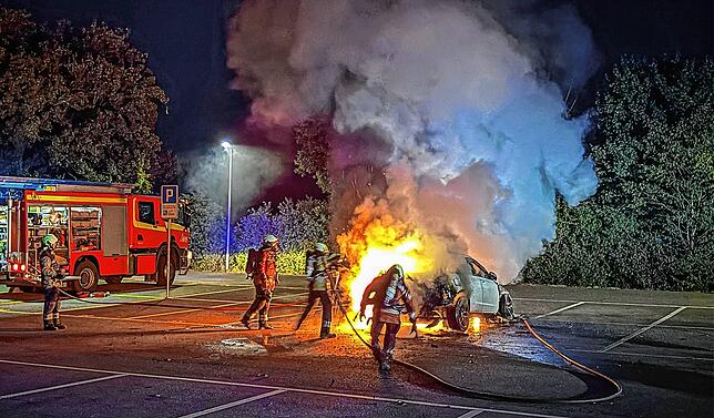 Die Feuerwehrleute löschen in Reinach (Kanton Basel-Landschaft) einen Autobrand.