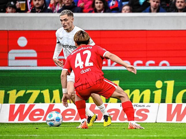 Leverkusens Florian Wirtz (l) in Aktion gegen Freiburgs Ritsu Doan (r).