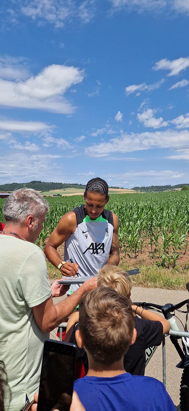 Virgil Van Dijk schreibt Autogramme für die Fans.
