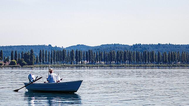 Ein Fischer in seinem kleinen Boot vor der Reichenau.