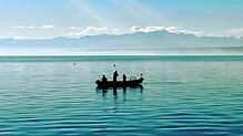 Angeln vom Boot aus – mit Blick auf die Alpen und die Angel im Wasser. Doch auch auf dem See gelten klare Regeln.