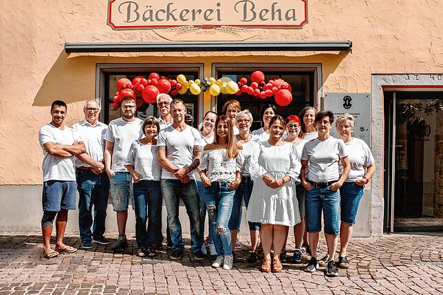 Die Familie Beha mit ihren Mitarbeitern vor der Bäckerei.