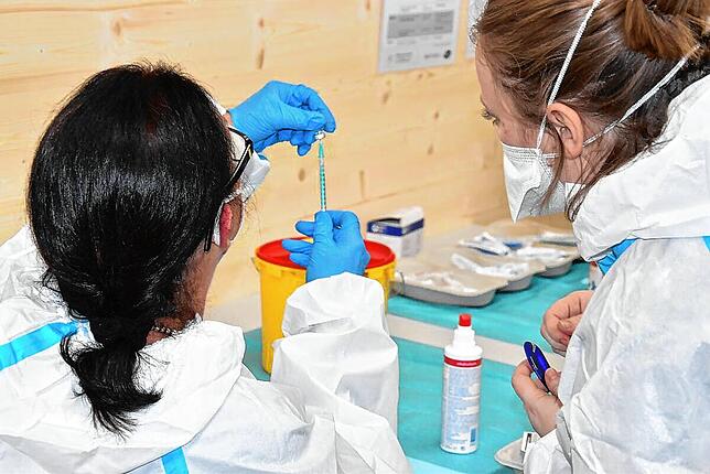 Medizinische Fachangestellte entsorgen im Kreisimpfzentrum leere Ampullen.