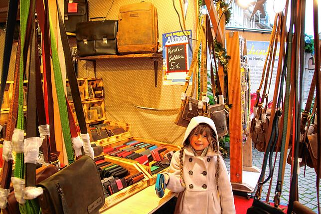 Eine Kindergeldbörse für 5 Euro ist das Angebot zum Familientag am Taschenstand. Aliya findet aber die Geldbörsen für Erwachsene ...