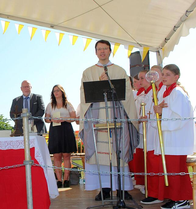 Auf dem Freiluft-Altar gestaltet Pfarrer Thomas Stricker (vorne) den Gottesdienst.