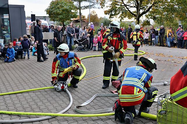 Feuerwehrkräfte überprüfen die Schläuche während des Einsatzes.