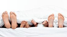 Mit dem Nachwuchs im Familienbett: Was harmonisch und liebevoll aussieht, ist für das Elternpaar der Lustkiller Nummer 1.