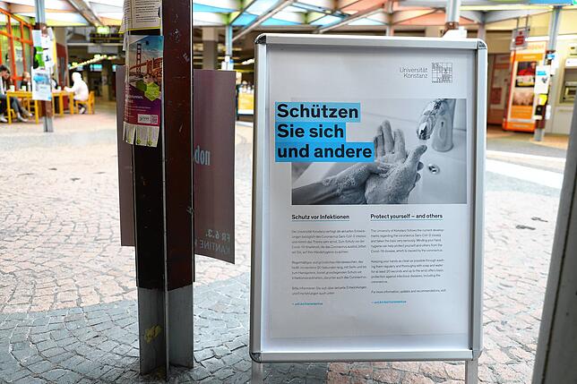 An der Uni: Aufforderung an Mitarbeiter und Studierende, Hygienemaßnahmen einzuhalten.