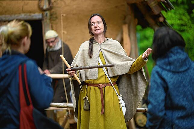 Museumspädagogin Sonja Fecht erklärt Besucherinnen im Campus Galli, wie die Menschen im Mittelalter gemessen und Längen bestimmt haben.