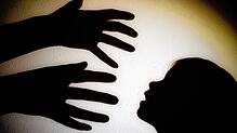 Schatten von Händen einer erwachsenen Person und dem Kopf eines Kindes. (Symbolbild)