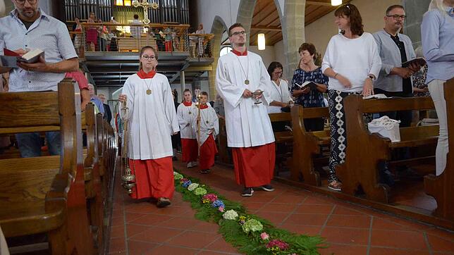 Den Gang im Hauptschiff der Pfarrkirche St. Nikolaus haben Mitglieder der Markdorfer Trachtengruppe mit Farn und Blüten ausgelegt.