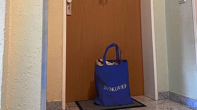 Eine SÜDKURIER Tasche voller Waren steht vor einer Tür. Auch nach dem Einkauf muss der Mindestabstand zwischen Helfer und Hilfesuchendem ...