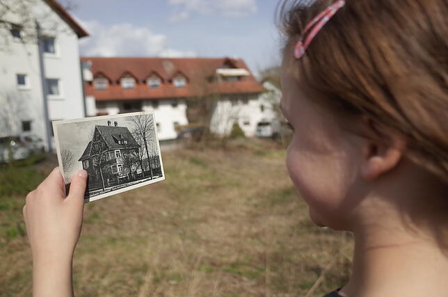 Ein Kind hält im Frühjahr 2021 eine Postkarte des Kinderkurheims Villa Hilda in der Hand. Das abgebildete einstige Bad Dürrheimer ...