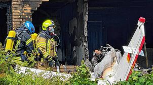 Schwer beschädigt ist ein Wohnhaus nach dem Absturz eines Flugzeugs. Bei dem Unglück sind mindestens zwei Menschen ums Leben gekommen.