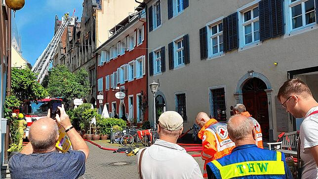 Auch am Tag nach der Brandnacht qualmt es aus dem Haus an der Zollernstraße 10, was viele Bürger und Touristen mit dem Handy festhalten.