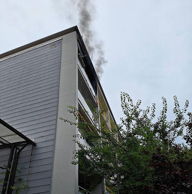 Im vierten Geschoss eines Gebäudes steht ein Balkon in Flammen.