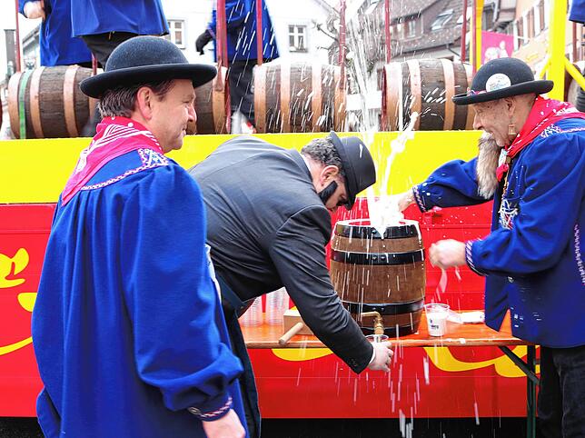 Es spritzt das Freibier: links Narrenvater Sven, Bürgermeister Tobias Link, Narrenrat Franz Scholz bei der Einweihung des neuen ...