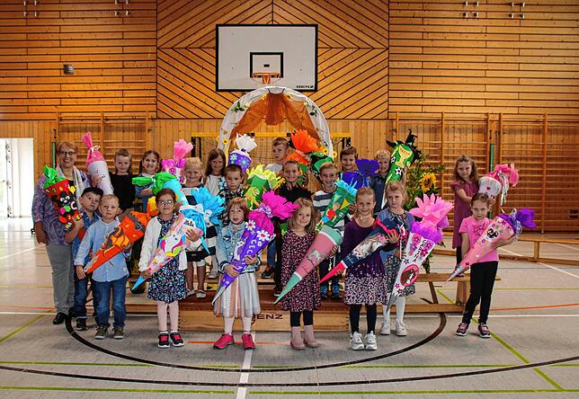 Wildensteinschule Leibertingen: Mit dem symbolischen Durchschreiten des geschmückten Schultors starten die Erstklässler, zwölf Mädchen ...