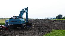Auf der Erweiterungsfläche für das Gewerbegebiet Im Breitenfeld trägt ein Bagger den Oberboden ab. Foto: Stefan Limberger-Andris