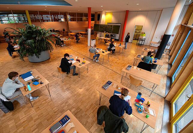 Für Abschlussklassen gelten Ausnahmen. Dann werden Schüler so wie hier zur Abiturprüfung an ihren Tischen mit großem Abstand in der Aula ...