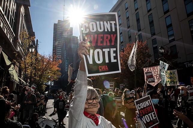 PHILADELPHIA, PENNSYLVANIA - NOVEMBER 05: A woman participates in a protest in support of counting all votes as the election in ...