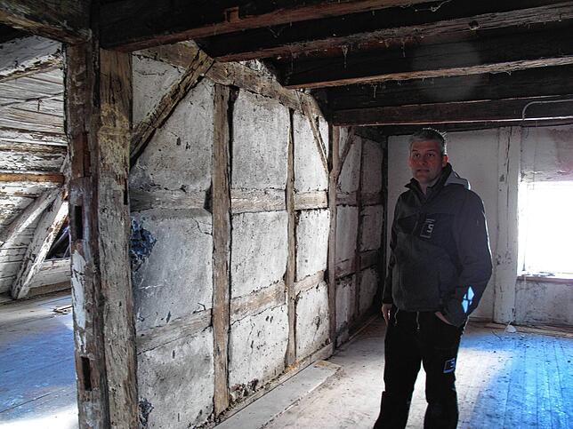 Sebastian Schmäh vor der Wand, deren historisches Fachwerk Aufschluss über das Baujahr des Urmühlenbaus: Er wurde nicht, wie erst von ...
