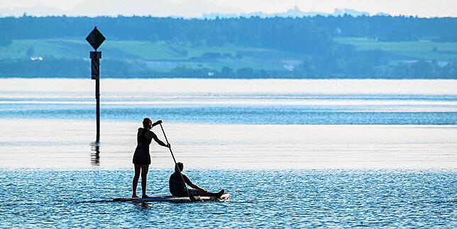 Eine Frau paddelt mit ihrem Kind auf einem Stand-up-Paddle über den Bodensee. Wie andere muss sie ihr Brett laut Schifffahrtsordnung mit ...