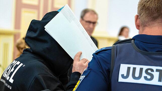 Der Angeklagte (l), wird vor Prozessbeginn in den Gerichtssaal geführt. Er wurde für seinen verhängten Doppelmord lebenslang verurteilt. ...