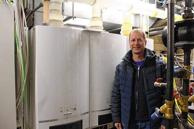 Pfarrgemeinderat Stephan Kessler vor der neuen Heizungsanlage. Sie sorgt dafür, dass die Arbeiten im Winter weitergehen können.