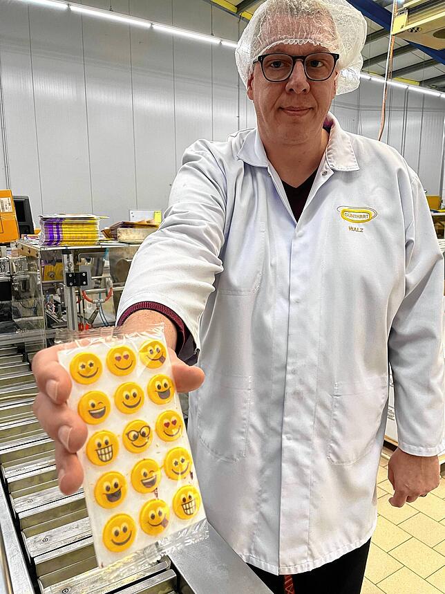 Betriebsleiter Thorsten Walz zeigt Dekoration aus weißer Schokolade, die es in Lebensmittelgeschäften wie Edeka oder Lidl zu kaufen gibt.