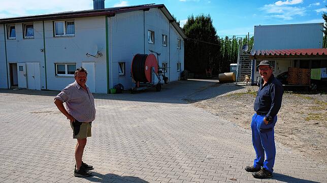 In einem Anbau und drei Containern bringt Hubert Bernhard, hier mit Dieter Mainberger, seine Erntehelfer unter.
