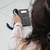 Eine Frau greift zum Telefonhörer. Immer wieder nutzen organisierte Banden das Telefon, um meist ältere Menschen dazu zu manipulieren, ...