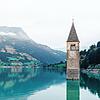 Der Kirchturm des alten Dorfs Graun, das vom Stausee am Reschenpass überflutet wurde, ist allein ein Grund, einmal auf dieser Route nach ...