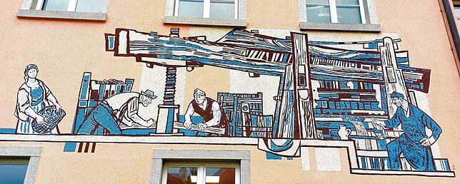 Das Betriebsgebäude der Kellerei ist mit einem Graffito verziert, es stellt die alte Torkel dar.