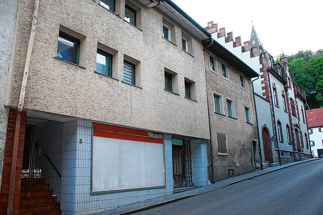 Im Vordergrund die beiden Abbruchhäuser, wo der Neubau hin soll. Im Hintergrund das alte Rathaus.