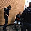 Zwei Polizisten nehmen die Personalien des Masken-Muffels auf.