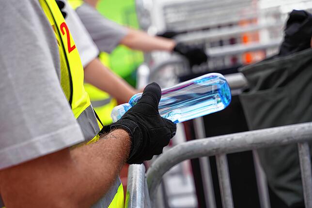Mitgebrachte Wasserflaschen sind verboten, werden aber am Eingang abgestellt. Die Besucher können sie später wieder abholen.