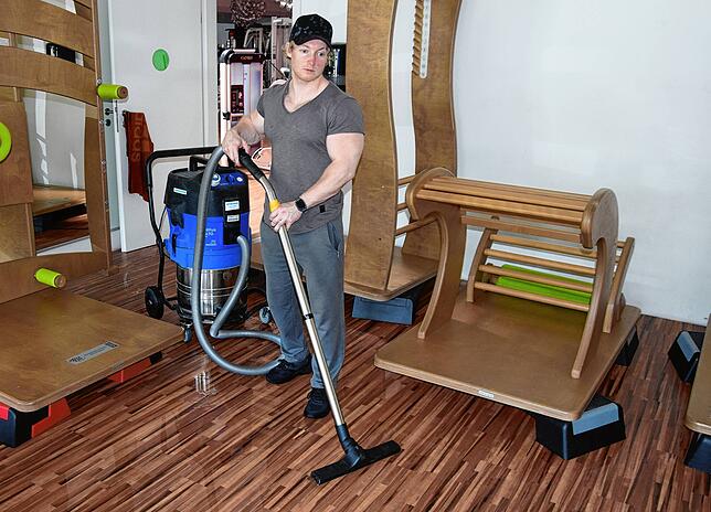 Mit einem Wassersauger versucht Fitnesstrainer Luca Kaps unermüdlich das bei Songül Premium Fitness eingedrungene Wasser zu beseitigen.