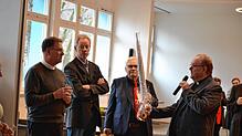 Ein besonderes Geschenk hat Pfarrer Jan Grzeszewski (rechts) für Dekan Peter Nicola (links) bereit: Ein Regenschirm mit einer Zeichnung ...