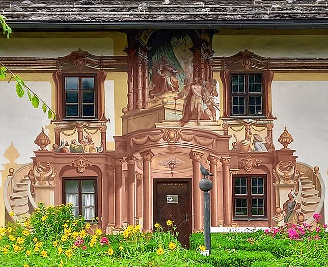 Oberammergau ist bekannt für seine prächtig verzierten Hausfassaden, die „Lüftlmalerei“. Hier das Petrushaus.