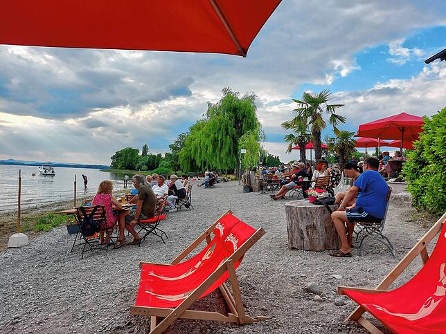 Ein Sommernachtstraum: Tische, Stühle und Relax-Sessel direkt am Strand der Sandseele.