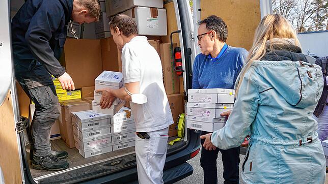 Mykhailo Volianiuk (links) und Hans-Walter Vollert (Zweiter von rechts) verladen mit weiteren Helfern die Hilfsgüter für das ...