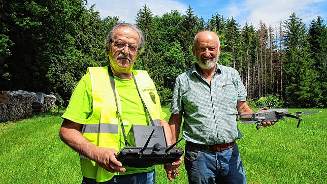 Manfred Rünzi (links) und Bernhard Huber zeigen eine Drohne und die Steuerung, um Rehkitze in Wiesen zu orten.