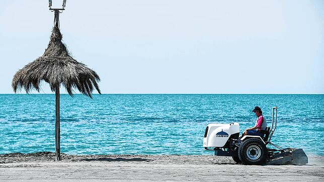Ein Strandarbeiter bereitet einen Strand bei Rom vor. Hier können nun auch wieder deutsche Urlauber liegen.