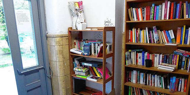 Im Treppenaufgang eines alten Kasernenblocks ein Regal zum Einstellen und Ausleihen von gebrauchten Büchern, geteiltes Eigentum in der ...