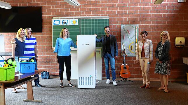 Kein Kühlschrank steht hier in der Grundschule Mühlhausen-Ehingen, sondern ein Luftfiltergerät &ndash; dank der Spende (von links) von ...