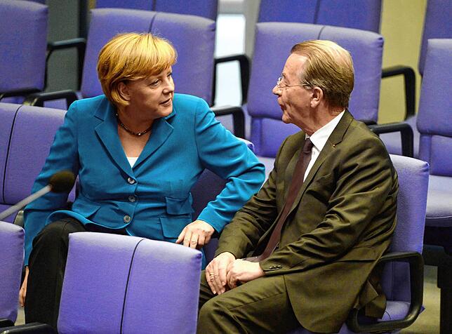 Altkanzlerin Angela Merkel und Müntefering unterhalten sich 2013 im Bundestag.
