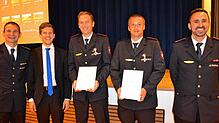 Kreisbrandmeister Michael Reitter (links) ehrt Thomas Renz (Dritter von rechts) für 25-jährige Feuerwehrarbeit mit der Ehrenurkunde in ...